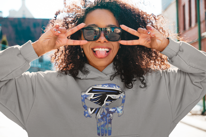 Smiling woman wearing a gray adult unisex sponge fleece pullover hooded sweatshirt with Sharon Springs Falcons “Punisher" logo and sunglasses posing with hands next to face