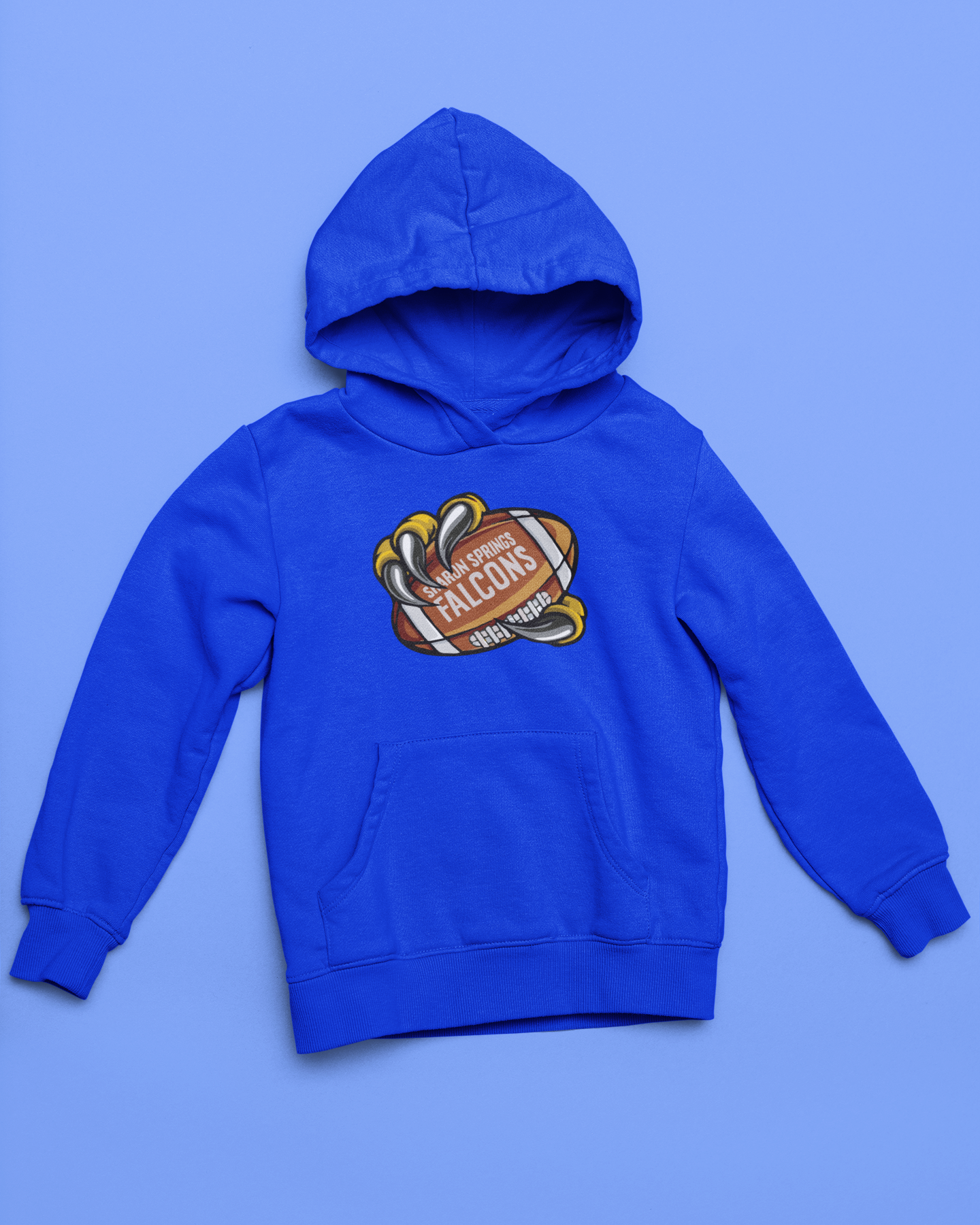 Royal blue youth unisex sponge fleece pullover hooded sweatshirt with Sharon Springs Falcons  "Talon Grab" football logo placed against a solid blue surface