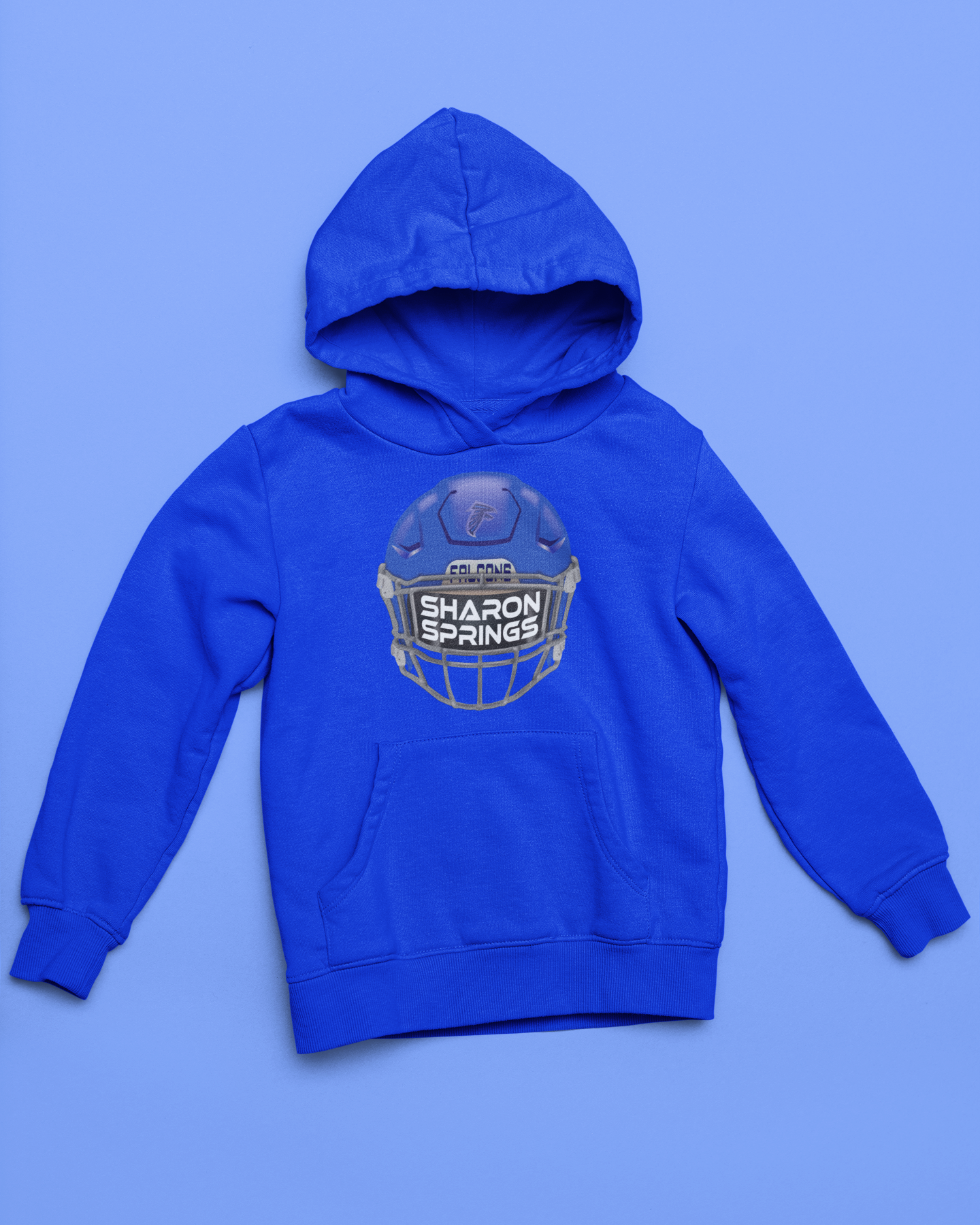 Royal blue youth unisex sponge fleece pullover hooded sweatshirt with Sharon Springs Falcons  "Real Helmet" logo placed against a solid blue surface