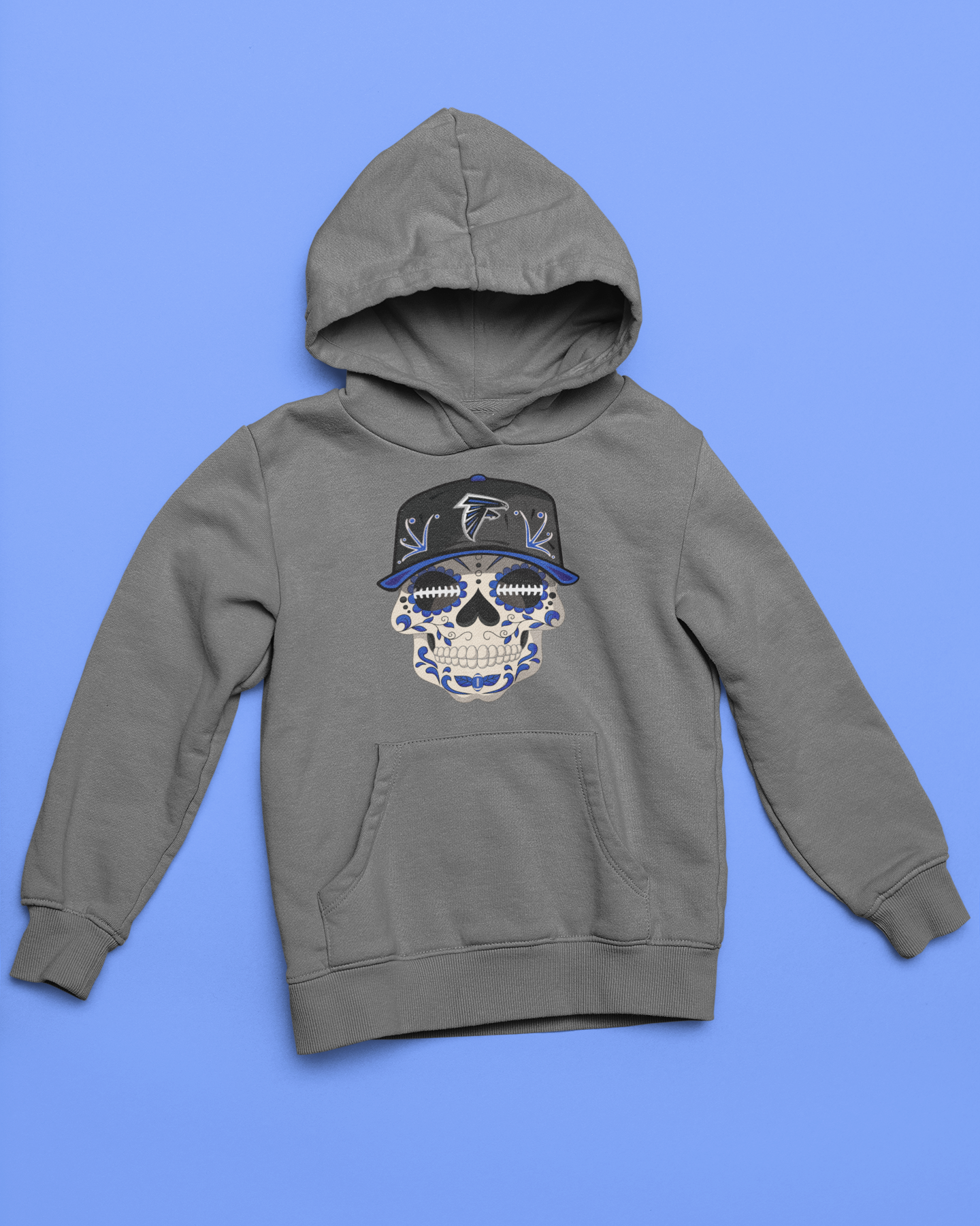 Gray youth unisex sponge fleece pullover hooded sweatshirt with Sharon Springs Falcons  "Sugar Skull" logo placed against a solid blue surface