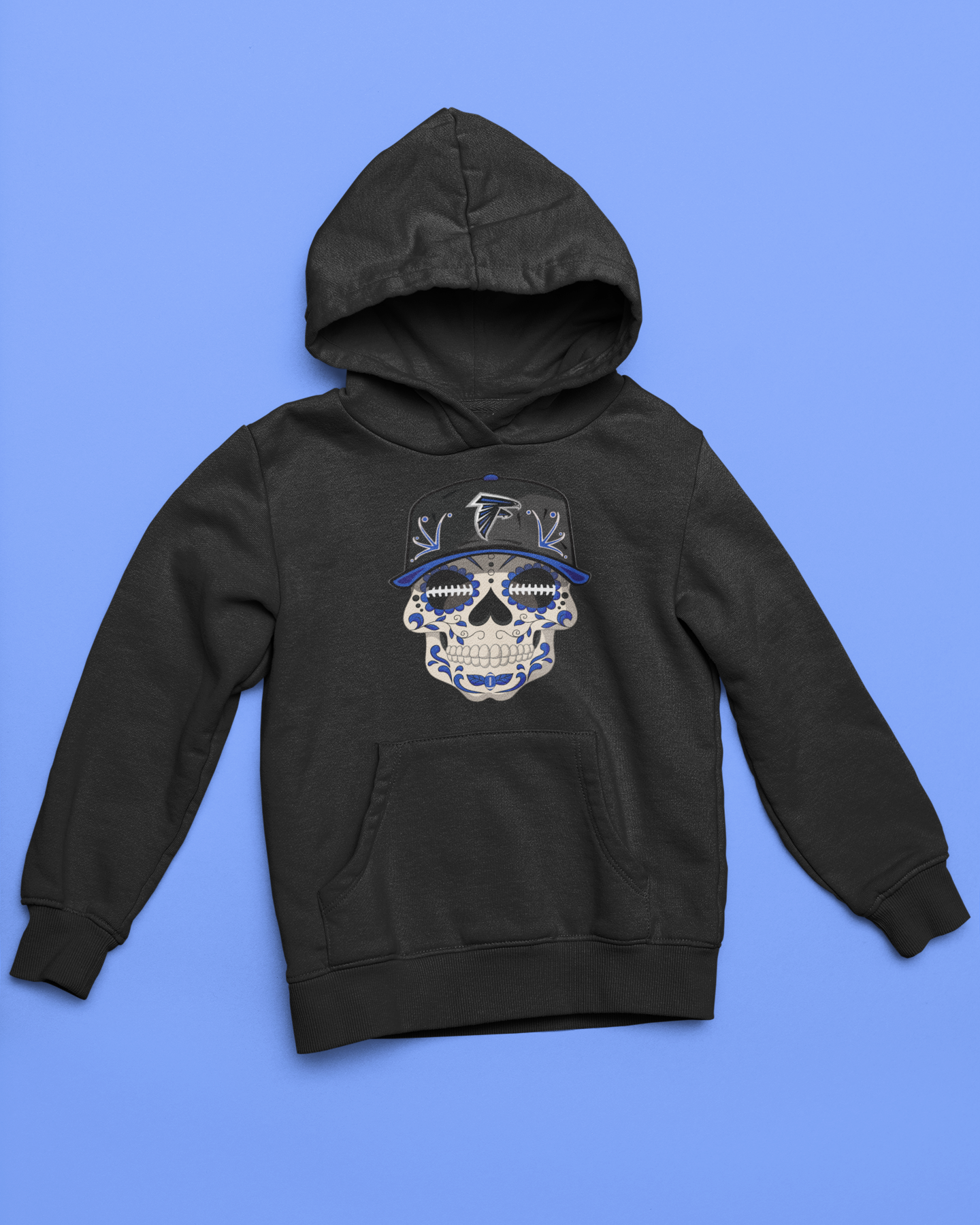 Black youth unisex sponge fleece pullover hooded sweatshirt with Sharon Springs Falcons  "Sugar Skull" logo placed against a solid blue surface